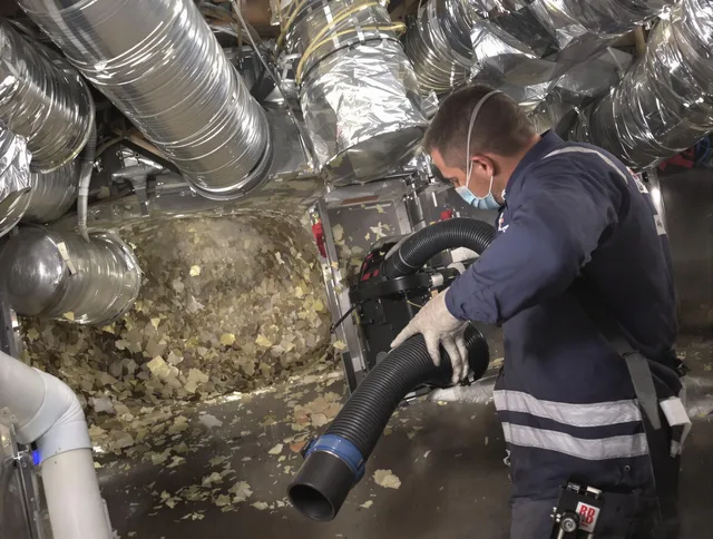 Burrillville Air Duct Cleaning specialist operating negative pressure cleaning equipment for thorough duct maintenance in Burrillville