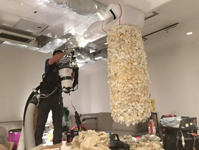 Burrillville Air Duct Cleaning technician performing precision vacuum insulation removal in a residential property in Burrillville